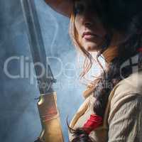 girl cowboy with  gun on a gray background