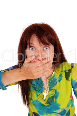 Surprised woman with hand on mouth.