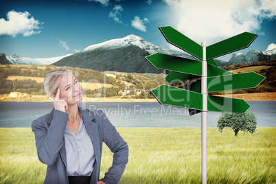 Composite image of businesswoman thinking with finger on head