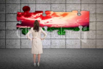 Composite image of businesswoman standing back to camera