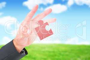 Composite image of businessman holding hand out