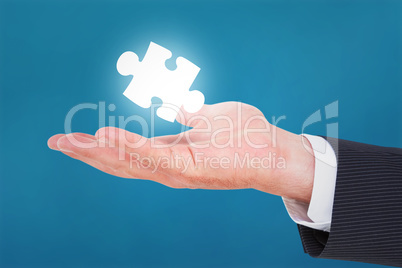 Composite image of businessman with wrist watch and hands out