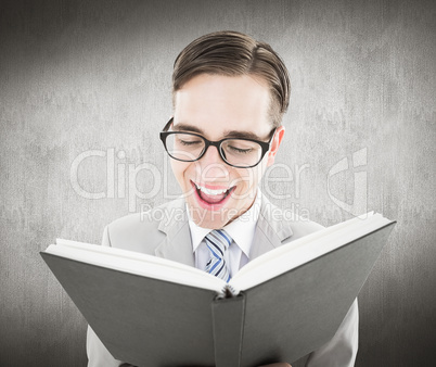 Composite image of geeky preacher reading from black bible