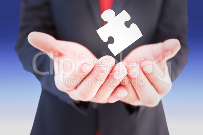 Composite image of businessman presenting with his hands