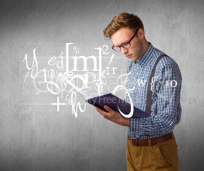 Composite image of geeky student reading a book