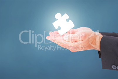 Composite image of businessman holding his hands out