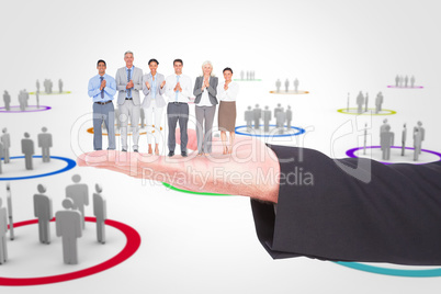 Composite image of smiling business people applauding