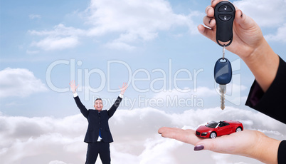 Composite image of woman holding key and small car