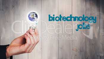 Composite image of hand holding environmental light bulb