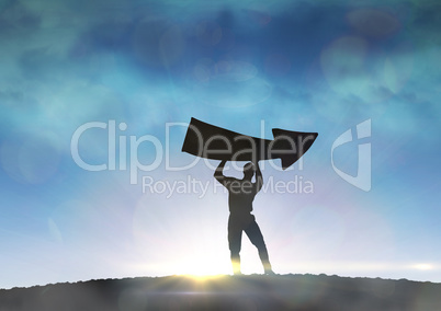 Composite image of businessman holding arrow