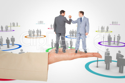 Composite image of businessmen shaking hands