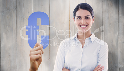 Composite image of smiling businesswoman with arms crossed at of