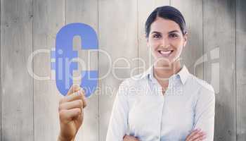 Composite image of smiling businesswoman with arms crossed at of