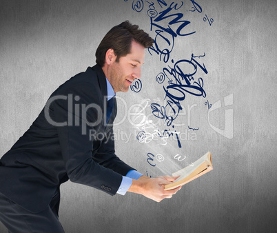 Composite image of businessman lying on the floor while reading