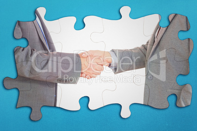 Composite image of close up on two businesspeople shaking hands