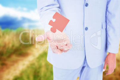 Composite image of handsome businessman gesturing with hands