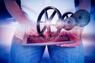 Composite image of woman using tablet pc Composite image of woman using tablet pc