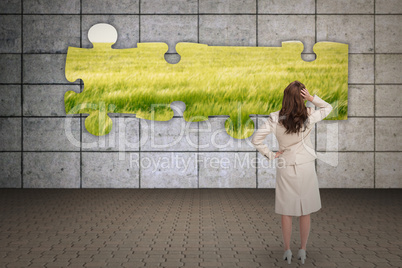 Composite image of businesswoman standing back to camera with ha