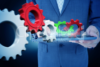 Composite image of  close up view of businessman using tablet co