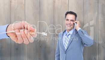 Composite image of  portrait of a successful businessman on phon