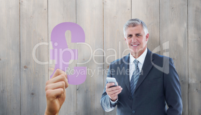 Composite image of smiling businessman using his smartphone