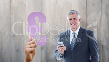 Composite image of smiling businessman using his smartphone