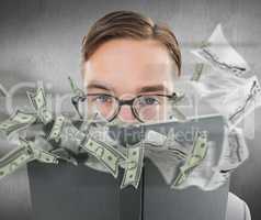 Composite image of geeky man looking over book