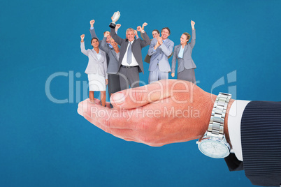 Composite image of excited business team cheering at camera with