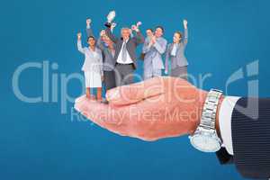 Composite image of excited business team cheering at camera with