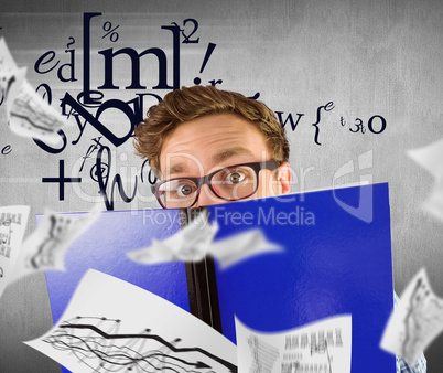 Composite image of geeky student reading a book