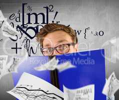 Composite image of geeky student reading a book