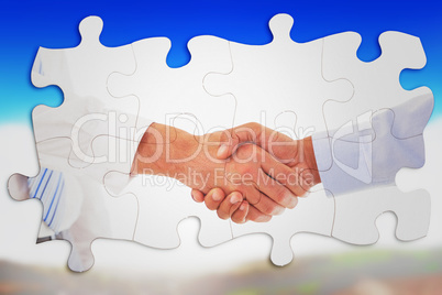 Composite image of close-up shot of a handshake in office