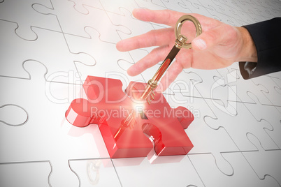 Composite image of businessman holding hand out