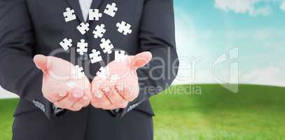 Composite image of businessman holding his hands out