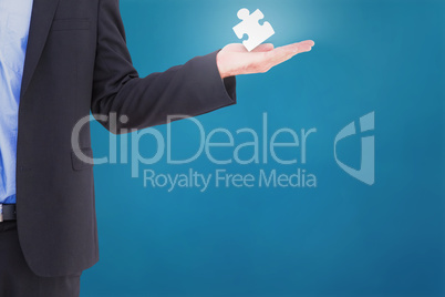 Composite image of businessman holding hand out in presentation Composite image of businessman holding hand out in presentation