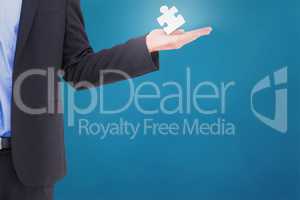 Composite image of businessman holding hand out in presentation