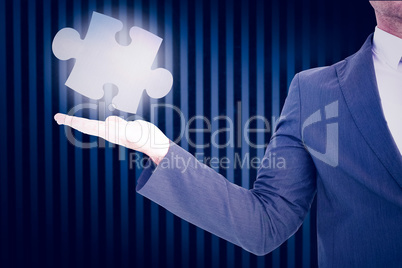 Composite image of businessman with his hand out