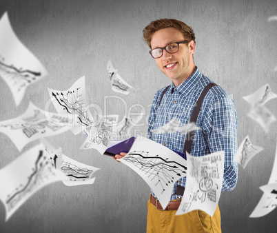 Composite image of geeky student reading a book