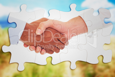 Composite image of close-up shot of a handshake in office