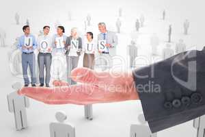 Composite image of business people holding letters sign