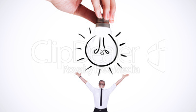 Composite image of hand holding light bulb doodle