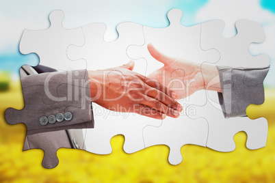 Composite image of businessman going shaking a hand