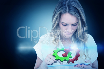 Composite image of woman using tablet pc