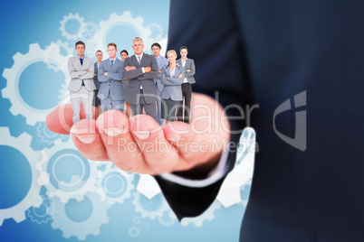 Composite image of business team standing arms crossed