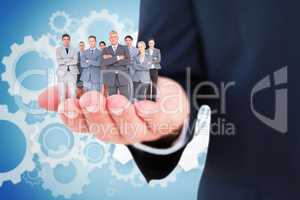 Composite image of business team standing arms crossed