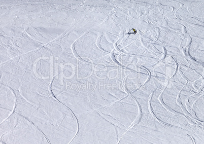Snowboarder downhill on off piste slope with newly-fallen snow