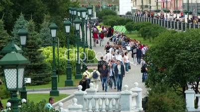 Crowd of people walking on Alexander's garden on Manezh square in Moscow, Russia