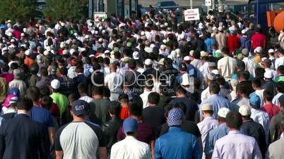 Muslims prayers on celebration of Eid al-Fitr (Uraza-Bairam). Crowd of migrants from Central Asia in Moscow, Russia