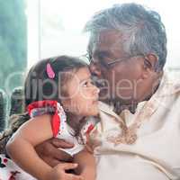 Grandfather kissing granddaughter