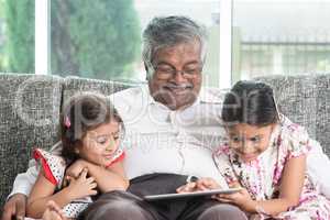 Grandfather and granddaughter using modern technology